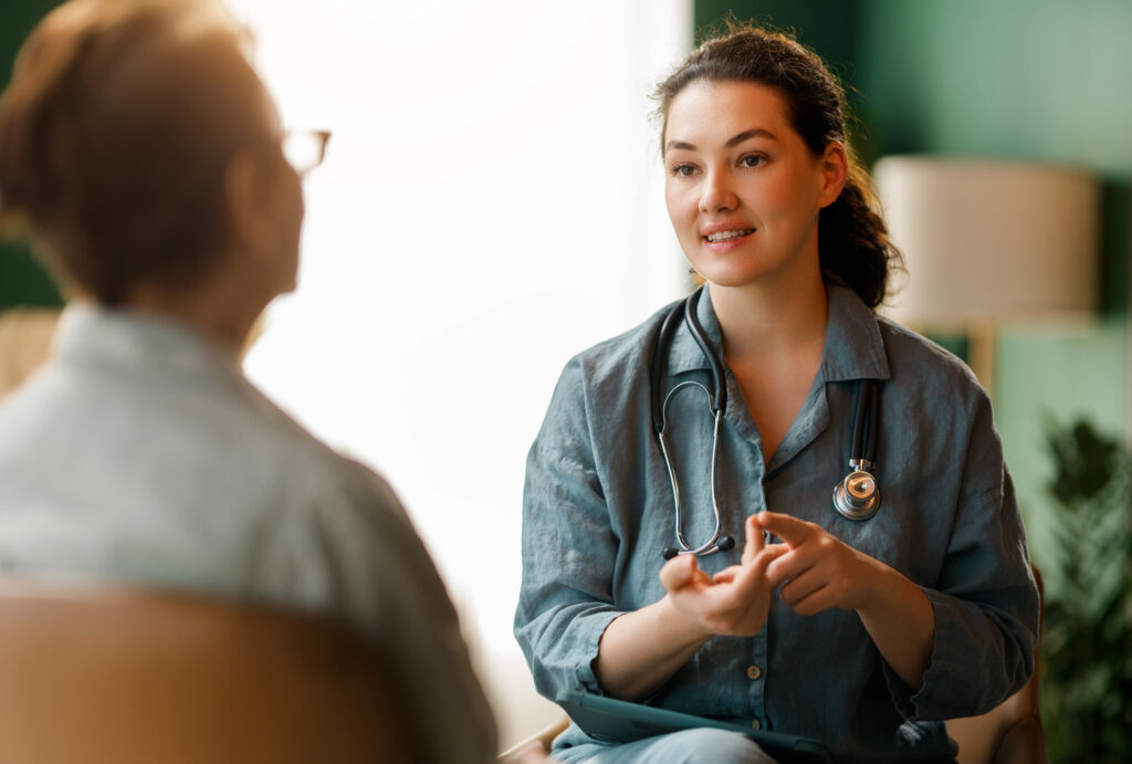Female patient and a doctor talking in hospital