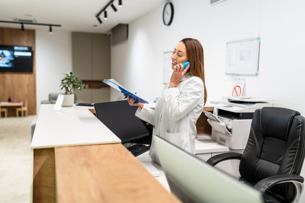 Woman at front desk reception medical practice